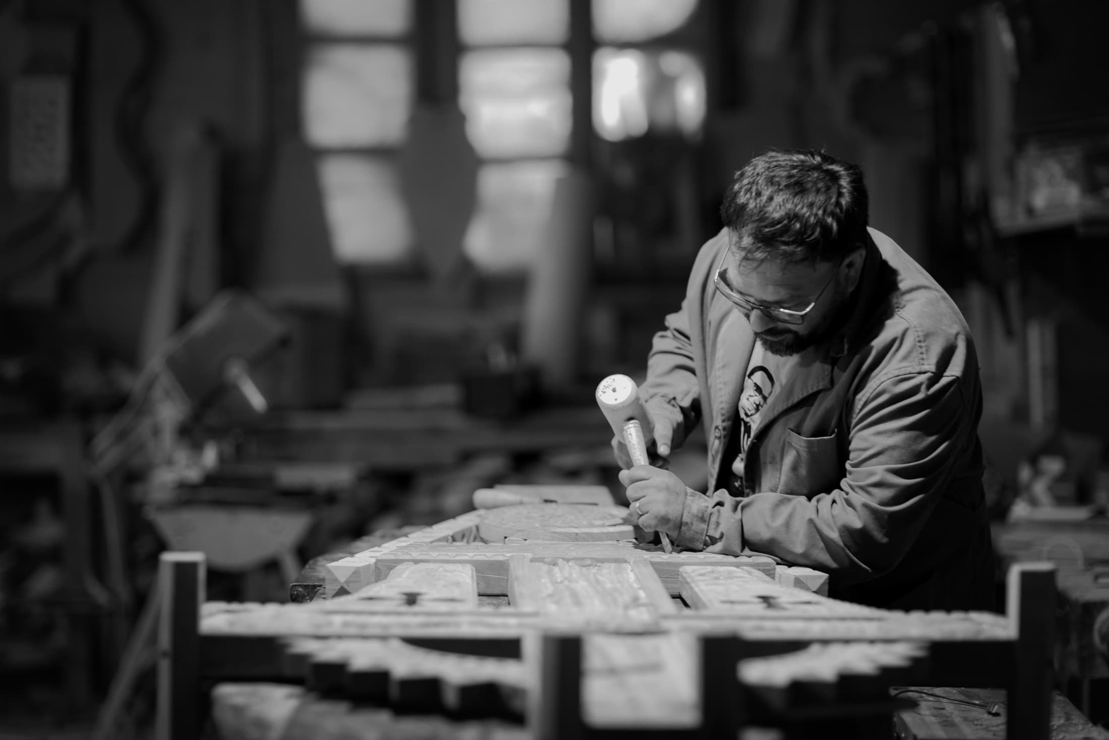 A local craftsperson working wood in the workshop