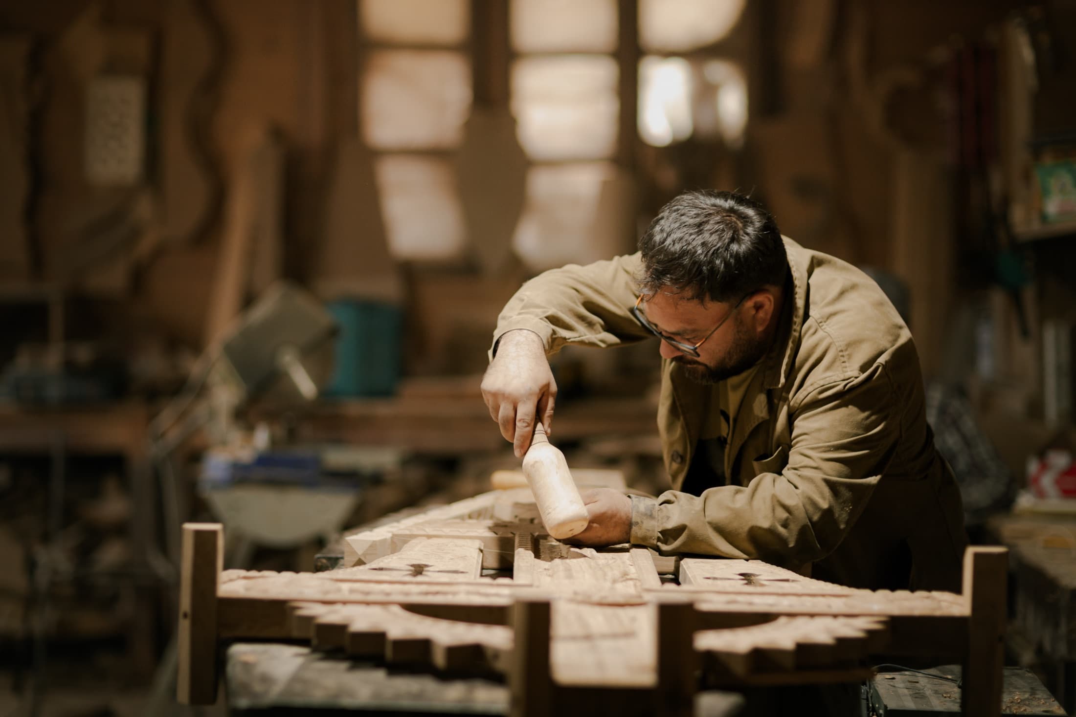 A local craftsperson working wood by hand in the workshop